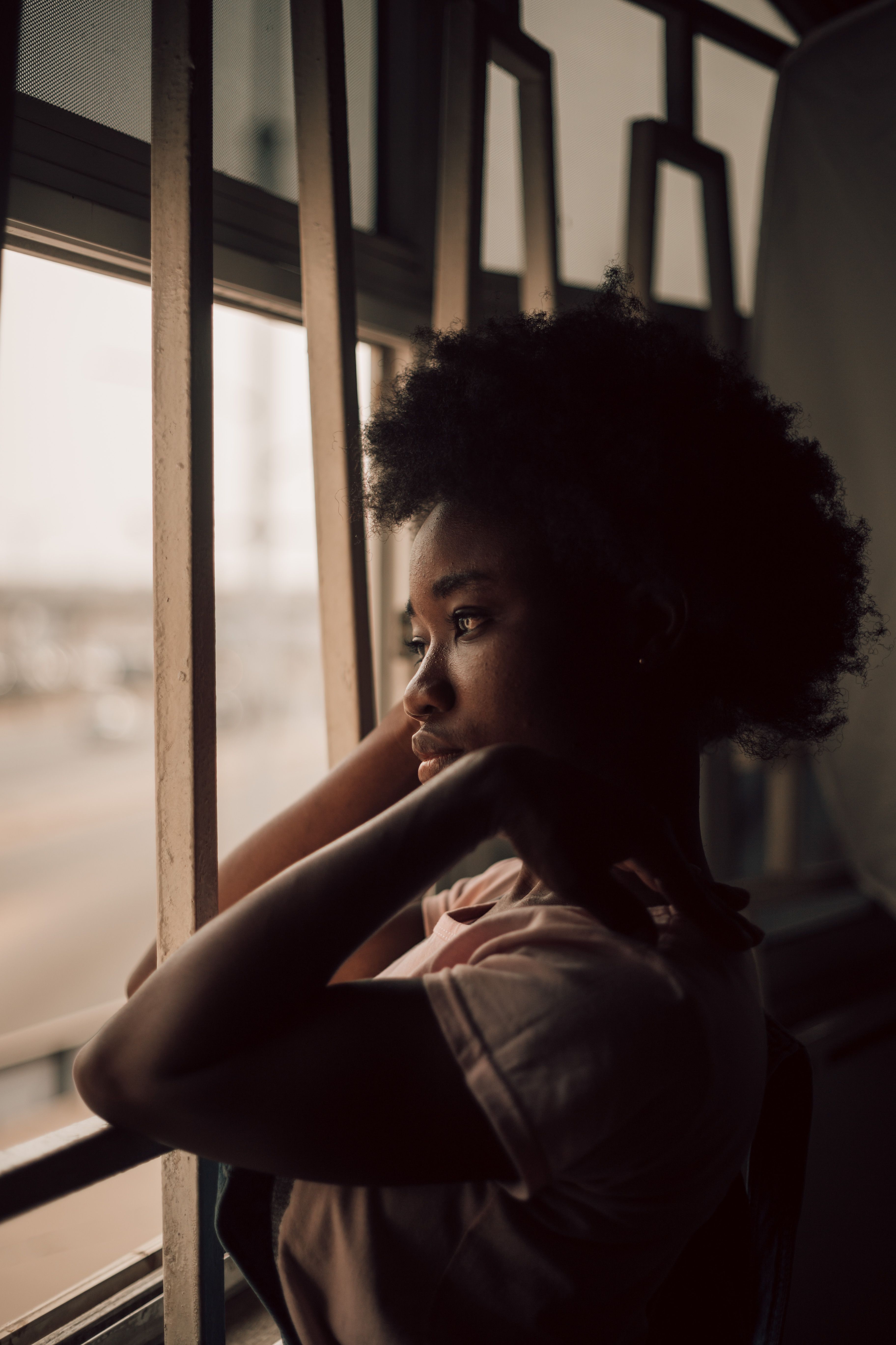 A person in a quiet, reflective moment, looking out a window - the stillness the diagnostic is meant to compose
